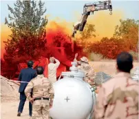  ?? AFP ?? A team of Libyan experts and military engineers monitor a dump tank under the supervisio­n of the UN in Tripoli. —