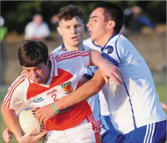  ??  ?? David Begley, Naomh Malachi is tackled by Cillian Gregory, Lannleire during the Group D JFC game atPáirc Mochta. Pictures: Aidan Dullaghan