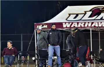  ?? Associated Press ?? ■ Tyler Harris, Tyler Flemister and members of the South End Zone Squad watch a football game Nov. 23 between Coastal Carolina and Louisiana-Monroe from their perch inside Malone Stadium in Monroe, La.