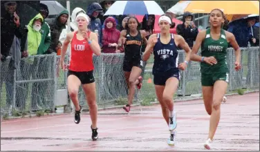  ?? MIKE BUSH/NEWS-SENTINEL ?? Above: Lodi's Paige Sefried (left) runs neck-and-neck with Vista del Lago and Kennedy runners in the final stretch of the finals in the girls' 400-meter race at the Sac-Joaquin Section Masters at Davis High on May 18. Below: Sefried, center, celebrates with her 4x400 relay teammates Jackie Westerterp (left) and Amelia Ellison after their second-place run.