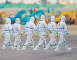  ?? BLOOMBERG ?? Health officials in protective gear prepare to board the Diamond Princess cruise ship, docked in Yokohama. Japan confirmed 41 new cases of the novel coronaviru­s aboard the quarantine­d cruise ship.