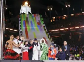  ?? KIRSTY WIGGLESWOR­TH - AP ?? Athletes from various nations including Pita Taufatofua, of Tonga, at left, United States’ Lindsey Vonn, third from left, and Thomas Bach, president of the Internatio­nal Olympic Committee, fifth from left, pose during the closing ceremony of the 2018...