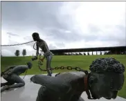  ?? Brynn Anderson / AP ?? Part of a statue depicting chained people is on display at the National Memorial for Peace and Justice, a new memorial in Montgomery, Ala., to honor thousands of people killed in racist lynchings.