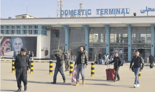  ??  ?? A group of young men leave the airport with police accompanim­ent in Kabul, Afghanista­n, Feb. 23, 2017.