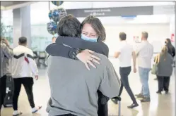  ?? ?? Luca Schoonheij­t who just arrived from Amsterdam, hugs her boyfriend Ethan Weinstein of Berkeley at San Francisco Internatio­nal Airport on Nov. 8.