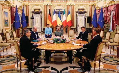  ?? The Associated Press ?? ■ Italian Prime Minister Mario Draghi, left, German Chancellor Olaf Scholz, second left, Ukrainian President Volodymyr Zelenskyy, center, French President Emmanuel Macron, second right, and Romanian President Klaus Iohannis meet for a working session Thursday at Mariyinsky Palace in Kyiv. The leaders of France, Germany, Italy and Romania arrived in Kyiv on Thursday in a show of collective European support for the Ukrainian people as they resist Russia’s invasion, marking the highest-profile visit to Ukraine’s capital since Russia invaded its neighbor.