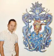  ??  ?? Boholano artist Henri Cainglet beside his artwork “Seeing the Dragon in Me.” Henri is best known for his found object works.