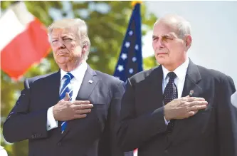  ?? Reuters-Yonhap ?? U.S. President Donald Trump and Homeland Security Secretary John Kelly listen to the national anthem during commenceme­nt exercises at the U.S. Coast Guard Academy in New London, Conn., in this May 17 photo. Trump moved to overhaul his senior team,...
