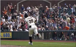  ?? JEFF CHIU — THE ASSOCIATED PRESS ?? Fans cheer as the Giants’ Thairo Estrada rounds the bases after hitting a three-run home run against the Milwaukee Brewers during the eighth inning in San Francisco on Thursday.