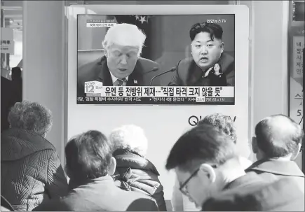  ?? AHN YOUNG-JOON / AP ?? Passersby making their way through the Seoul, South Korea, Railway Station watch a TV screen showing images of U.S. President Donald Trump, left, and North Korean leader Kim Jong Un in November. The scope and timing of recent U.S. military exercises, coming after North Korea’s ballistic missile tests, suggest a renewed focus on getting prepared for what could be on the horizon with Kim’s kingdom.