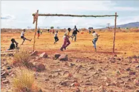  ?? ?? Foul play: Children enjoy a game of football on a dusty, rocky-strewn field in Ga-mafokane in the Fetakgomo Tubatse municipali­ty