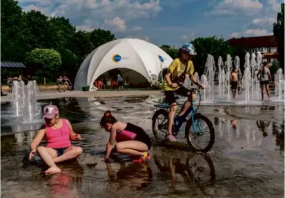  ?? BRENDAN HOFFMAN/NEW YORK TIMES ?? A UNICEF tent with resources for children stood near a public fountain in Bucha, Ukraine, in June.