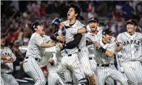  ?? ?? Japan celebrate after Shohei Ohtani, center, struck out Team USA’s Mike Trout to win the World Baseball Classic final. Photograph: Cristóbal Herrera/EPA