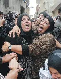  ?? MUSA AL-SHAER/AFP/GETTY IMAGES ?? Relatives mourn the death of a Palestinia­n boy shot by Israeli soldiers near Bethlehem. Four Israelis were killed last week in attacks in Jerusalem and the West Bank.