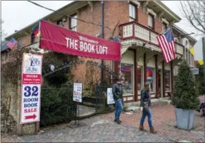  ??  ?? Customers depart the entrance path at The Book Loft of German Village in Columbus, Ohio. The 40-year-old bookstore features 32 rooms of books.