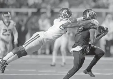  ?? Rick Bowmer Associated Press ?? USC defensive back Adoree’ Jackson has a grip on Utah receiver Tim Patrick, but Patrick keeps his grip on the ball during the first half and the Utes eventually rallied for the victory on a touchdown catch by Williams.