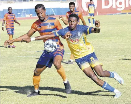  ?? (Photo: Joseph wellington) ?? Montego Bay United’s Nevaun Turner (left) fends off a challenge from Harbour View’s Kemar Mullings during the Jamaica Premier League encounter at Jamaica College’s Ashenheim Stadium on Sunday.