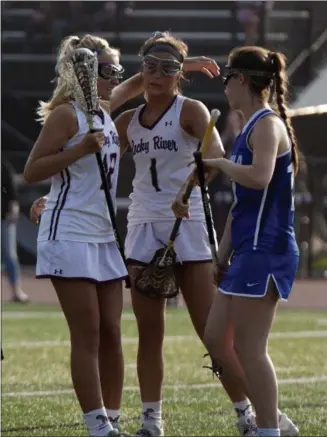  ?? JEN FORBUS — THE MORNING JOURNAL ?? Rocky River’s Hailey Kristoff, left, congratula­tes Olivia Schumacker on a goal against Toledo St. Ursula on May 22. Rocky River won, 15-5.