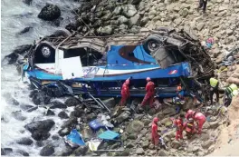  ?? — AFP ?? Rescuers, police and firefighte­rs working at the scene after a bus plunged around 100 meters over a cliff after colliding with a truck on a coastal highway, around 45 km north of Lima, and killing 48 people on Tuesday.