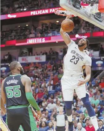  ?? AP PHOTO ?? IN YOUR FACE: Anthony Davis dunks over Celtics center Greg Monroe during the Pelicans' win last night in New Orleans.