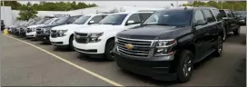  ?? AP PHOTO/PAUL SANCYA ?? In this Sept. 30 photo, a row of Chevrolet Suburban vehicles are shown at Wally Edgar Chevrolet in Orion Township, Mich. The strike has cost GM just over $1 billion, JP Morgan analyst Ryan Brinkman estimated Tuesday in a note to investors.