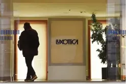  ??  ?? MILAN: A man enters in the building of Italian eyewear company Luxottica yesterday in Milan. French lensmaker Essilor said it has agreed to buy Italy’s Luxottica, maker of Ray-Ban sunglasses, in a bid to create a new global giant in the sector. —AFP
