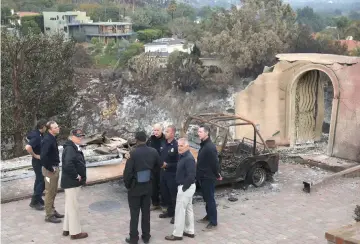  ??  ?? Trump (centre) surveys the damage from the Woolsey fire in Malibu. — AFP photo
