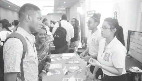  ??  ?? Participan­ts interactin­g with exhibitors at the Digital Wealth Creation Summit held at the Marriott Hotel on Saturday.