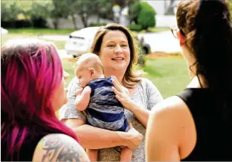  ?? HYOSUB SHIN PHOTOS / AJC ?? “We are a family scared to death,” says Christy Nelson (center), who benefited from Obamacare for her cancer treatment and fears the health law’s dismantlin­g. She holds grandson Harrison Heaney as she chats with daughters Taylor Heaney (left) and Madi...