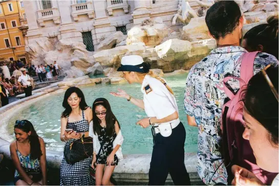  ??  ?? I vigili presidiano la Fontana di Trevi a Roma per impedire che i turisti bivacchino o si fermino troppo a lungo, creando ingorghi.
