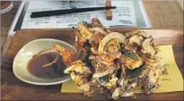  ?? Jay Jones ?? KAUBOI IZAKAYA in Reno serves such Japanese small bites as a tempura combo of shrimp, shiitake mushrooms and onions.