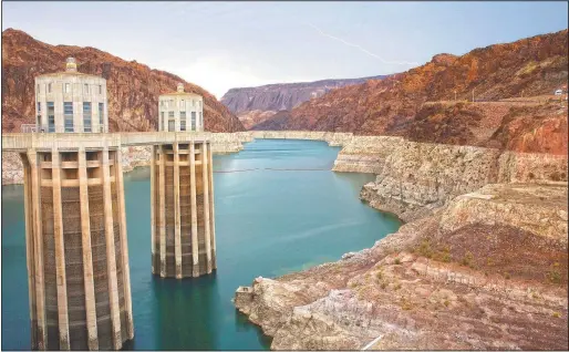  ?? (File Photo/AP/John Locher) ?? Lightning strikes in July 2014 over Lake Mead near Hoover Dam that impounds Colorado River water at the Lake Mead National Recreation Area in Arizona.