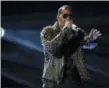  ?? PHOTO BY FRANK MICELOTTA/ INVISION/AP, FILE ?? In this June 30, 2013, file photo, R. Kelly performs onstage at the BET Awards at the Nokia Theatre in Los Angeles. Spotify has removed R. Kelly’s music from its playlists, citing its new policy on hate content and hateful conduct.