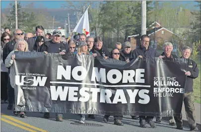  ?? CP PHOTO ?? Friends and family march to a service to honour the 26 coal miners who perished in the Westray Mine disaster at the Westray Miners Memorial Park in New Glasgow on Tuesday. The coal mine exploded twenty five years ago to the day on May 9, 1992.