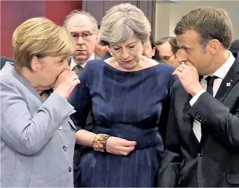  ??  ?? Whispering campaign: Theresa May with Chancellor Angela Merkel of Germany and Emmanuel Macron, the French president, on the first day of the European Council meeting