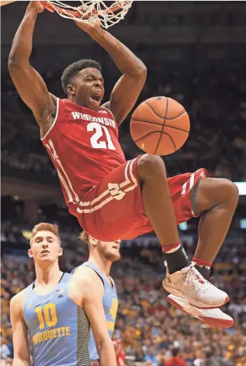  ?? JOHN KLEIN / FOR THE MILWAUKEE JOURNAL SENTINEL ?? Kahlil Iverson slams home a Badgers basket in the first half Saturday at the BMO Harris Bradley Center. Iverson, a sophomore, finished with a career-high 16 points, and Wisconsin pulled away from Marquette in the second half.