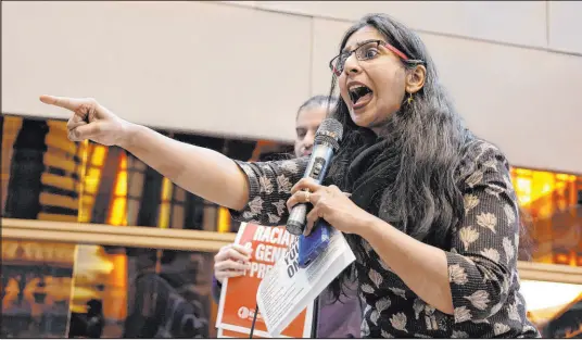  ?? John Froschauer The Associated Press ?? Seattle Council member Kshama Sawant speaks to supporters and opponents of a proposed ordinance to add caste to Seattle’s anti-discrimina­tion laws at a rally Tuesday at Seattle City Hall. Sawant proposed the ordinance.