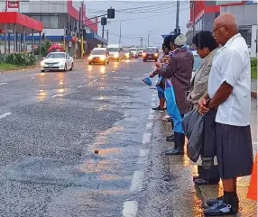  ??  ?? Opposition leader and caretaker SODELPA leader Sitiveni Rabuka, with wife, Suluweti, farewell former Prime Minister Laisenia Qarase as his funeral cortège travels along the Kings Road on Ratu Mara Road in Nabua yesterday on its way to the Nausori Internatio­nal Airport bound for Vanuabalav­u.