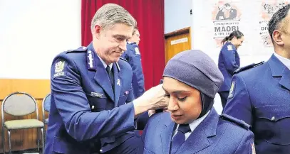  ?? PHOTO: NZ POLICE ?? New look . . . Constable Zeena Ali receives her epaulettes in November 2020, from Commission­er of Police, Andrew Coster. The hijab she is wearing as part of her police uniform was designed with help from Massey University,