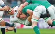  ?? ANDREW BOYERS / REUTERS ?? England’s Dylan Hartley is tackled by an Irish player during the Six Nations Championsh­ip match at Twickenham, London, on Saturday. Ireland sealed just its third Grand Slam of all time with a 24-15 win over the host.