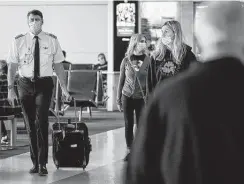  ?? Tribune News Service file photo ?? A pilot walks along the concourse at Dallas-Fort Worth Internatio­nal Airport. In urging American Airlines to fire some management team members, the board of the carrier’s pilots union pinned some periods of heavy cancellati­ons and flight delays this summer on the team that helps run day-to-day operations of the company.