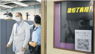  ?? GETTY IMAGES ?? Hong Kong police arrested Apple Daily publisher Jimmy Lai on Monday in his paper’s newsroom in order to make an example of him, Martin Regg Cohn writes.