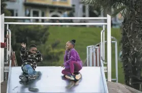  ?? Carlos Avila Gonzalez / The Chronicle ?? Cameron Hall, 5, and Bella Befford, 6, play on the slide at the Dolores Park playground in S. F. on Sunday, hours before COVID19 restrictio­ns took effect.