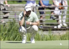  ?? CHRISTIAN KOLBERT — DPA ?? Germany’s Martin Kaymer squats on the green during the German Internatio­nal Open at Golfclub Muenchen Eichenried in Munich on Thursday.