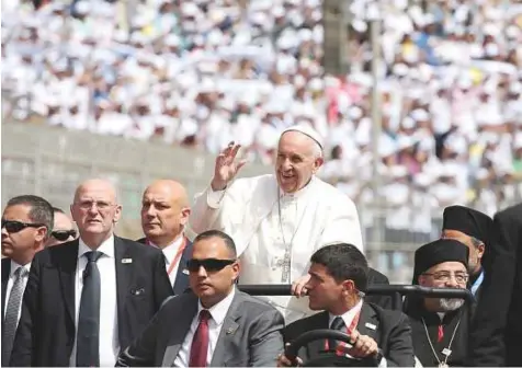  ?? Reuters ?? Pope Francis arrives to lead a mass at the Air Defence Satadium in Cairo yesterday. Around 15,000 people gathered in the stadium to listen to the Pope.