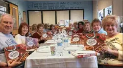  ?? Whitehall Public Library ?? Whitehall Public Library cookbook club members hold copies of Rachael Ray's “Everyone Is Italian on Sundays.” From left to right: Richard Welch, Jane Cass, Nancy Riley, Maryanne Gorman, Betty Steele, Anne Bratetich, Rosemary Borman, Lois Green, Grace Klein, Cheryl Priano, Sherry Ward and Michele Morgan.