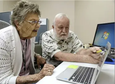  ??  ?? Navigating online: Marion Lysek ( left), gets pointers on using her new computer. — tNs