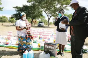  ??  ?? First Lady Auxillia Mnangagwa hands over a knapsack sprayer , disinfecta­nts, hand sanitisers and other personal protective equipment to Sister Flora Madziva during her interactiv­e session on Covid-19 at Gambiza Hall in Chiwundura yesterday. Looking on is Midlands Provincial Affairs and Devolution Minister Larry Mavima. — Picture: John Manzongo