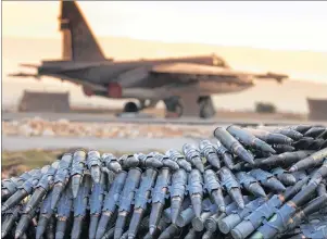  ?? RUSSIAN DEFENSE MINISTRY PRESS SERVICE VIA AP ?? A load of ammunition is prepared to be loaded on Russian war planes at Hemeimeem Air Base, in Syria.