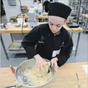  ?? DAVE JOHNSON THE WELLAND TRIBUNE ?? Lakeshore Catholic High School's Fallon Gervais works on dough during Niagara Catholic District School Board's baking and culinary skills competitio­n at the Niagara College Canadian Food and Wine Institute.